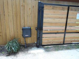 A gate operator installed on a wood driveway gate.