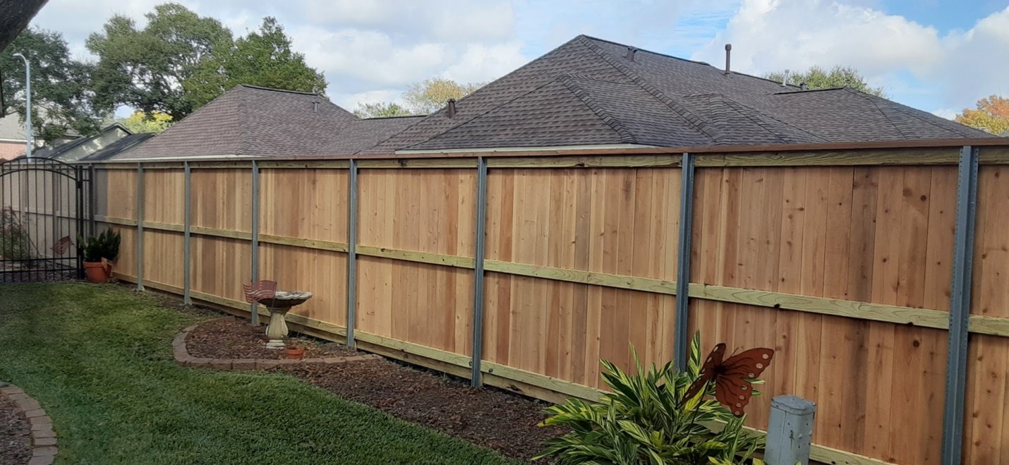 Brown metal profile fence with steel posts